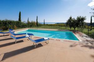 a swimming pool with two lounge chairs next to it at Villa Marchetti in Cupra Marittima