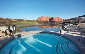 a swimming pool with a view of a golf course at Black Desert Resort in Ivins