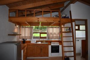 a loft bed in a kitchen with a sink and a stove at Loft-style cabin in Avandaro in Valle de Bravo +6 photos