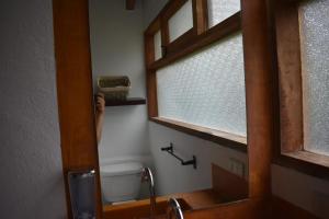 a bathroom with a window and a toilet in it at Loft-style cabin in Avandaro in Valle de Bravo