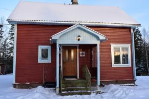 a red house with a door in the snow at Villa Frida in Kilen