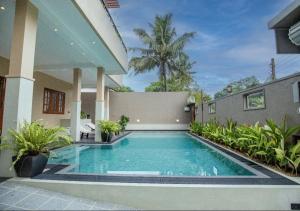 a swimming pool in the backyard of a house at Villa Freedom Hikkaduwa in Hikkaduwa