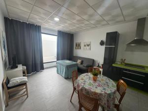 a living room with a table and a couch at Austria 03 in Lebrija