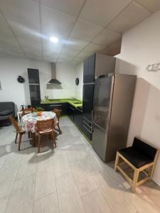 a kitchen with a dining table and a refrigerator at Austria 03 in Lebrija