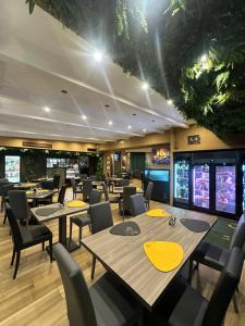 a restaurant with tables and chairs and televisions at Oasi Urbana in Casoria