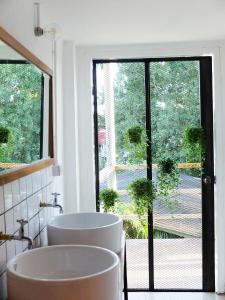a bathroom with two sinks and a large window at Green Sleep Hostel in Chiang Mai +43 photos