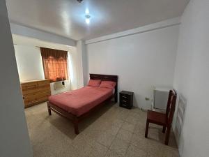 a bedroom with a bed and a chair in it at Hotel luque in Guayaquil