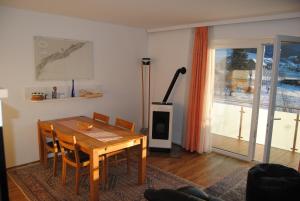 a dining room with a table and chairs and a fireplace at Fewo Ossiach in Ossiach