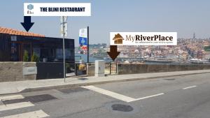 a road with a street sign next to a building at MyRiverPlace River View Porto apartments in Vila Nova de Gaia