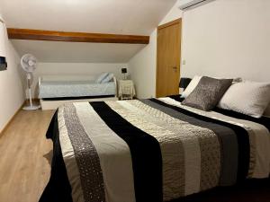 a bedroom with two beds and a bench in it at Casa Vilariça in Alfândega da Fé +33 photos