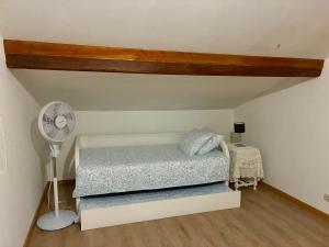 a bedroom with a bed and a fan at Casa Vilariça in Alfândega da Fé