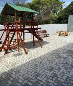 a picnic table and benches on a brick patio at Lisboa in João Pessoa
