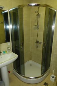 a shower with a glass door next to a sink at Metekhi Stay - Old Tbilisi in Tbilisi City +23 photos