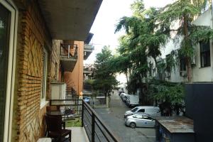 a balcony with a car parked on a city street at Metekhi Stay - Old Tbilisi in Tbilisi City