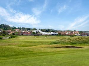 a view of a golf course with a green field at 3 Bed in Holt oc-1331 in Bodham