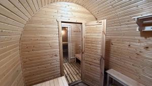 an inside view of a wooden sauna with an open door at Arrow Burabay in Borovoye +42 photos