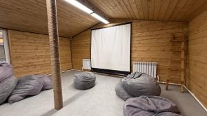 a room with four bean bags in front of a screen at Arrow Burabay in Borovoye