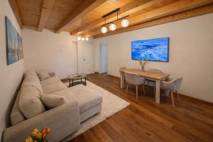 a living room with a couch and a table at Aurisina heart apartment in Aurisina