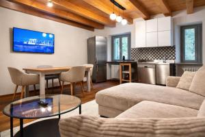 a living room with a couch and a table at Aurisina heart apartment in Aurisina
