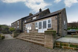 a brick house with stairs leading up to it at 5 Bed in Fryup Dale oc-wa291 in Danby
