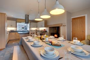 a kitchen with a table with plates and glasses on it at 5 Bed in Fryup Dale oc-wa291 in Danby