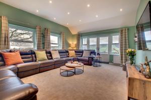 a living room with a couch and a table at 5 Bed in Fryup Dale oc-wa291 in Danby