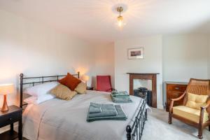 a bedroom with a bed and a desk and a chair at 2 Bed in Aylsham oc-s30931 in Aylsham