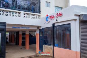 a store front of a building with a sign on it at Tataji Suites in Kisii