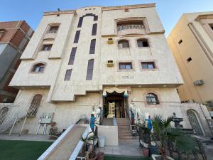 a building with a staircase leading up to the door at دار اليقين in Medina