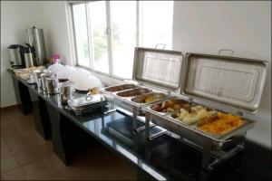 a buffet line with many different types of food at China Hotel in Canindé de São Francisco +6 photos