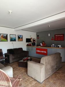 a living room with two couches and a counter at China Hotel in Canindé de São Francisco