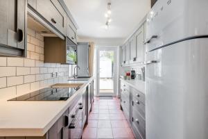 a kitchen with white cabinets and a red tile floor at 2 Bed in Whitstable oc-w31887 in Whitstable