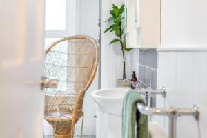 a bathroom with a rattan chair next to a sink at 2 Bed in Whitstable oc-w31887 in Whitstable +13 photos