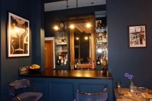a bar with a mirror and two chairs and a table at The Southbank Torquay by the sea in Torquay