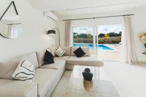 a living room with a couch and a glass table at Aiolia Villa in Lachania