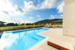 a swimming pool in a villa with a view at Aiolia Villa in Lachania