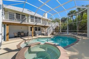 a house with a swimming pool and a balcony at Lighthouse Lookout in Sanibel