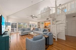 a living room with a staircase in a house at Lighthouse Lookout in Sanibel
