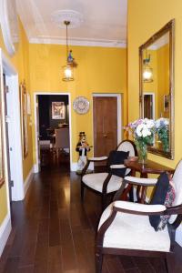 a living room with yellow walls and a table and chairs at The Southbank Torquay by the sea in Torquay