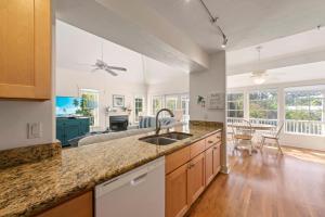 a kitchen with a sink and a living room at Lighthouse Lookout in Sanibel