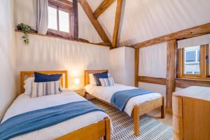 two beds in a room with two windows at 4 Bed in Etloe oc-e34026 in Awre +26 photos
