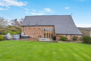 a brick house with a lawn in front of it at 4 Bed in Etloe oc-e34026 in Awre