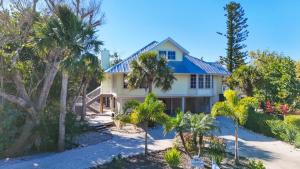 a house on the beach with palm trees at Lighthouse Lookout in Sanibel