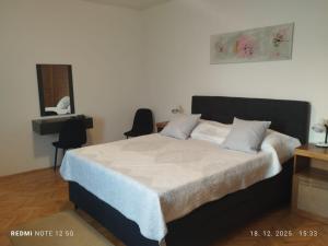 a bedroom with a large bed with two pillows at Nin Heritage Home in Nin
