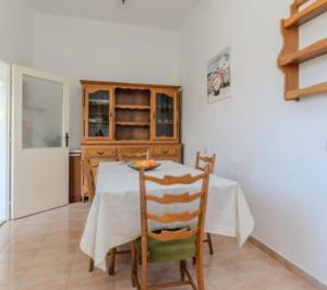 a dining room with a table and a kitchen at Nin Heritage Home in Nin +16 photos