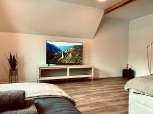 a bedroom with a flat screen tv on a wall at LYMA Suites - Apartment B44 in Immenstadt im Allgäu