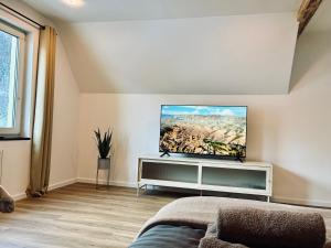 a living room with a flat screen tv on a wall at LYMA Suites - Apartment B44 in Immenstadt im Allgäu +22 photos