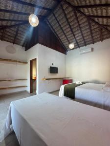 a hotel room with two beds and a tv at POUSADA AMORIM in Santo Amaro +148 photos