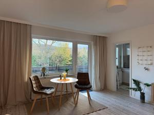 a living room with a table and chairs and a large window at Sweet Escape in Bad Pyrmont
