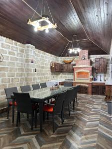 a dining room with a table and chairs and a fireplace at Sultan Villas A-Frame in Quba in Quba